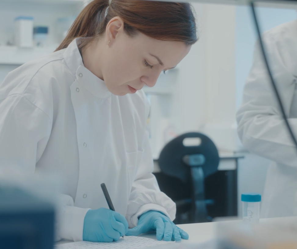 A researcher writing in the lab