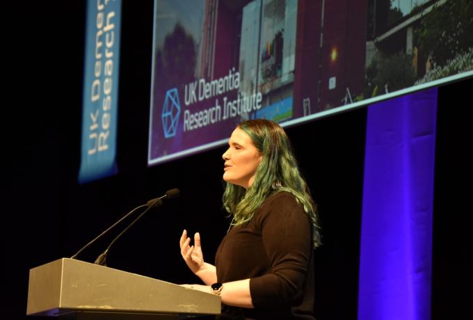 Person speaking to the audience at a lectern.