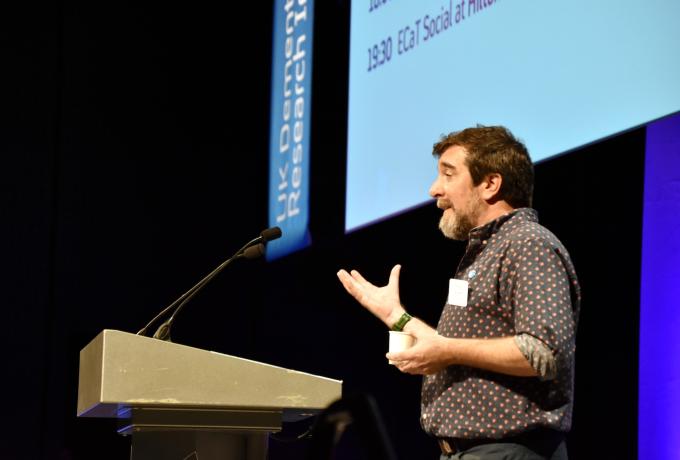 Person speaking to the audience at a lectern.