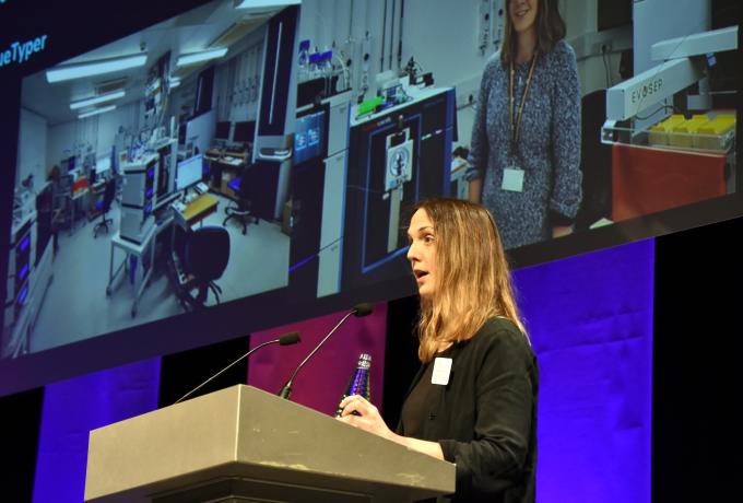 Person speaking to the audience at a lectern.