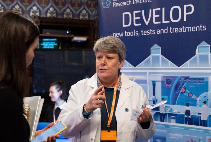 Scientist talks to an MP at the UK DRI parliamentary event