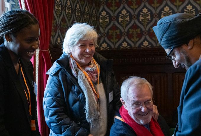 Minder participants speaking to an MP at the UK DRI parliamentary event