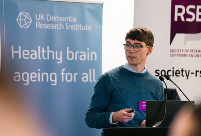 A researcher presenting slides in a parallel session