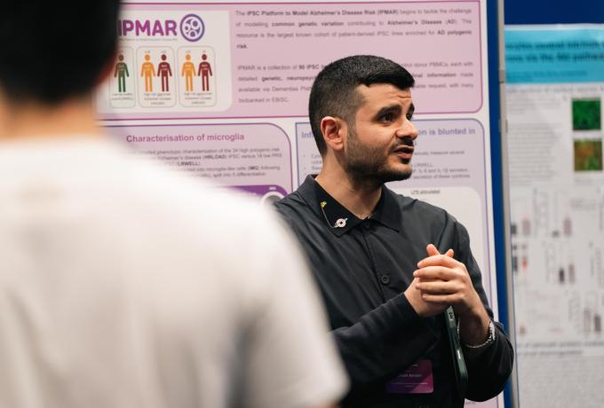 Researchers discuss a poster