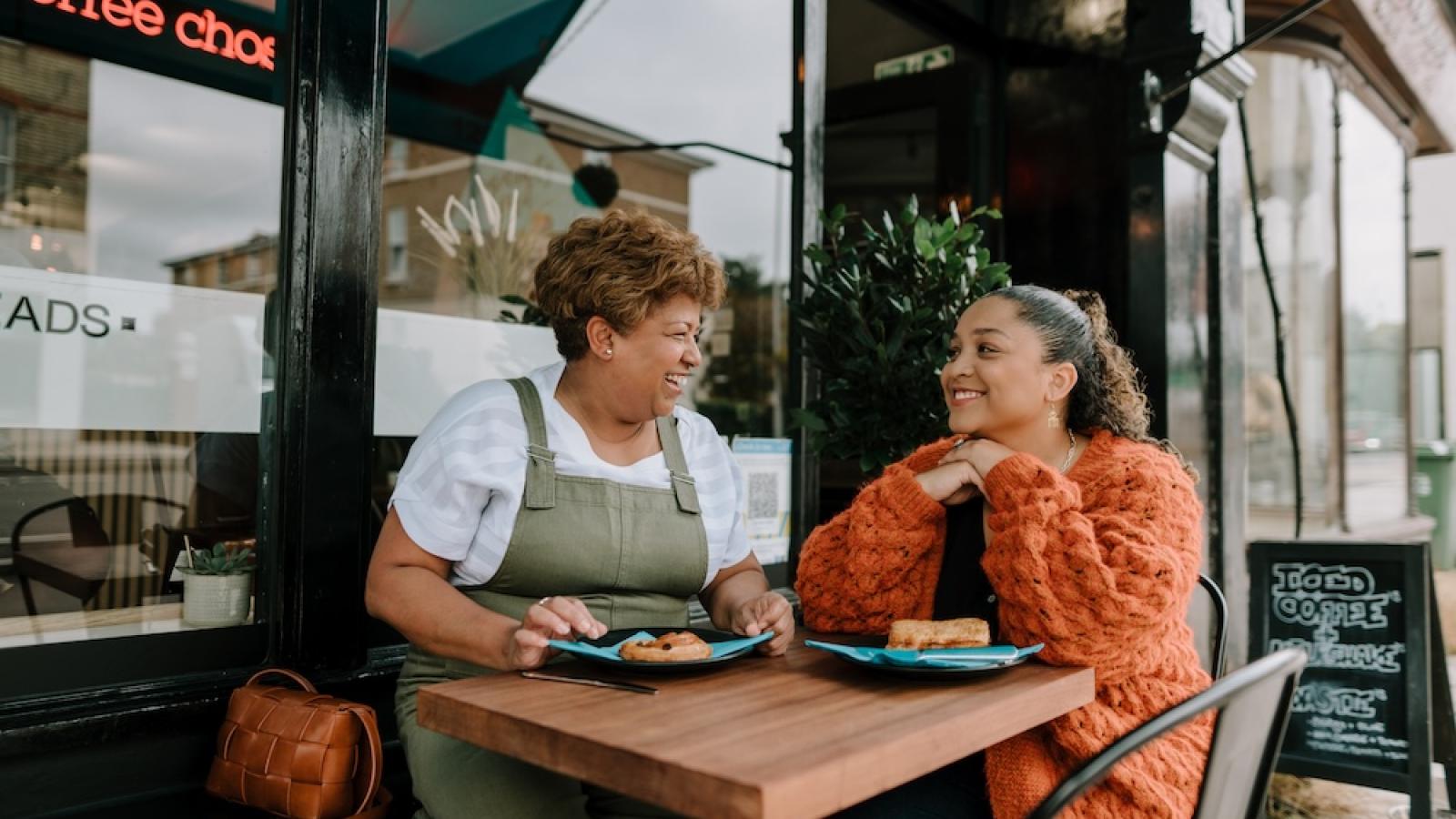 Women smiling at a cafe
