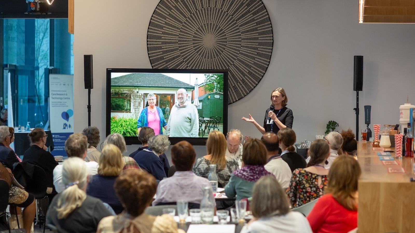 Room of people watching presentation