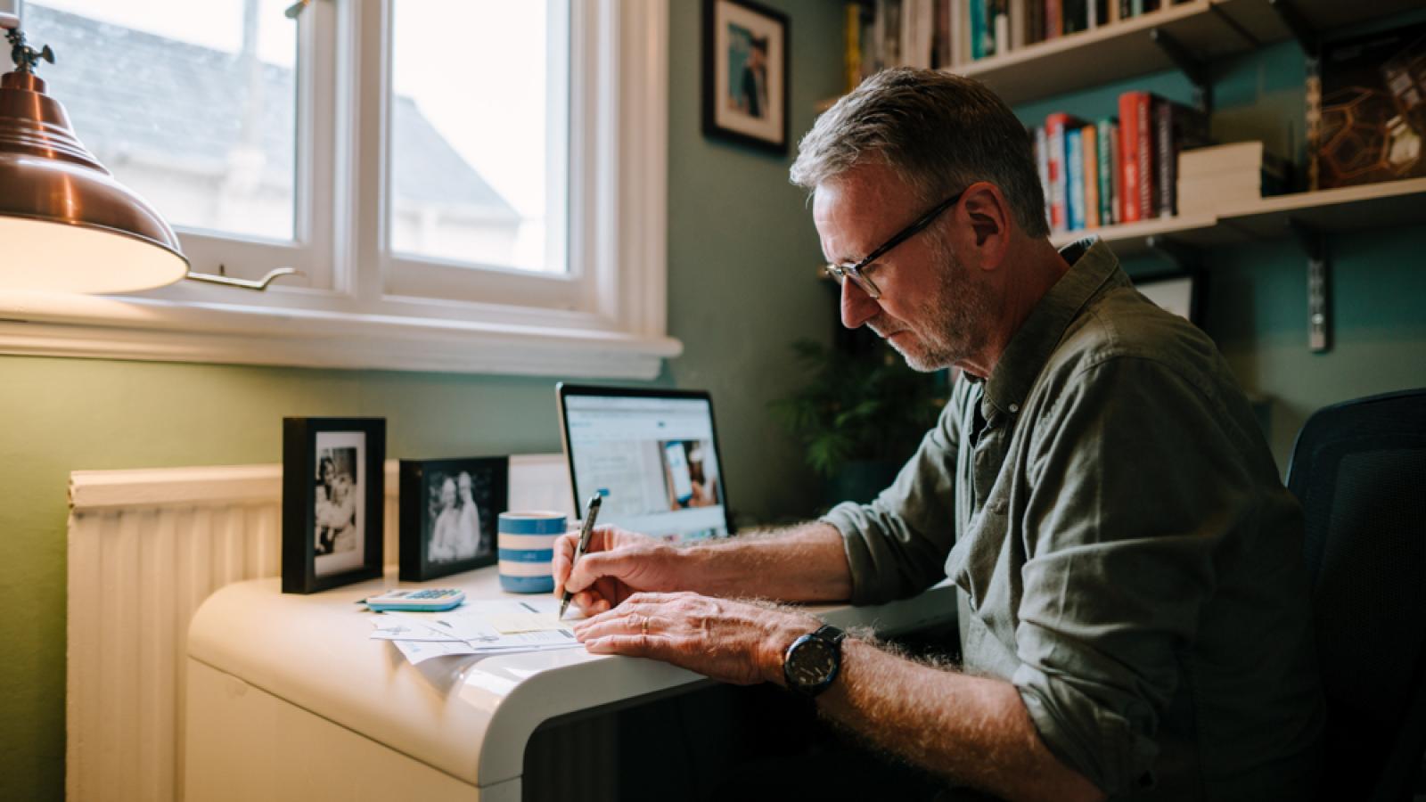 Man writing at desk