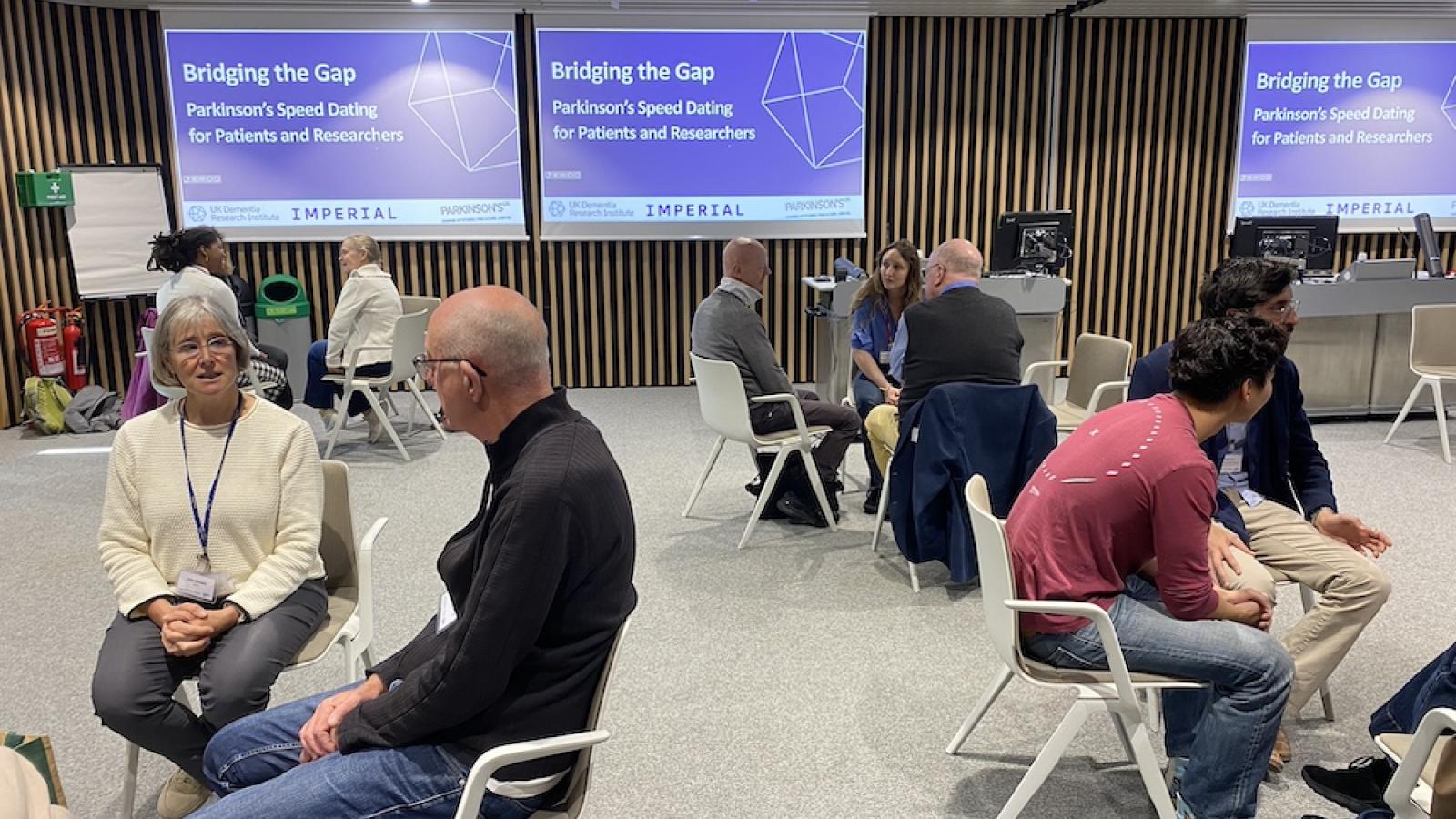 People sit in small groups at a speed networking event