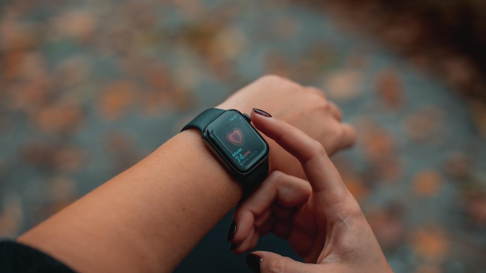 A woman looks at her smart watch