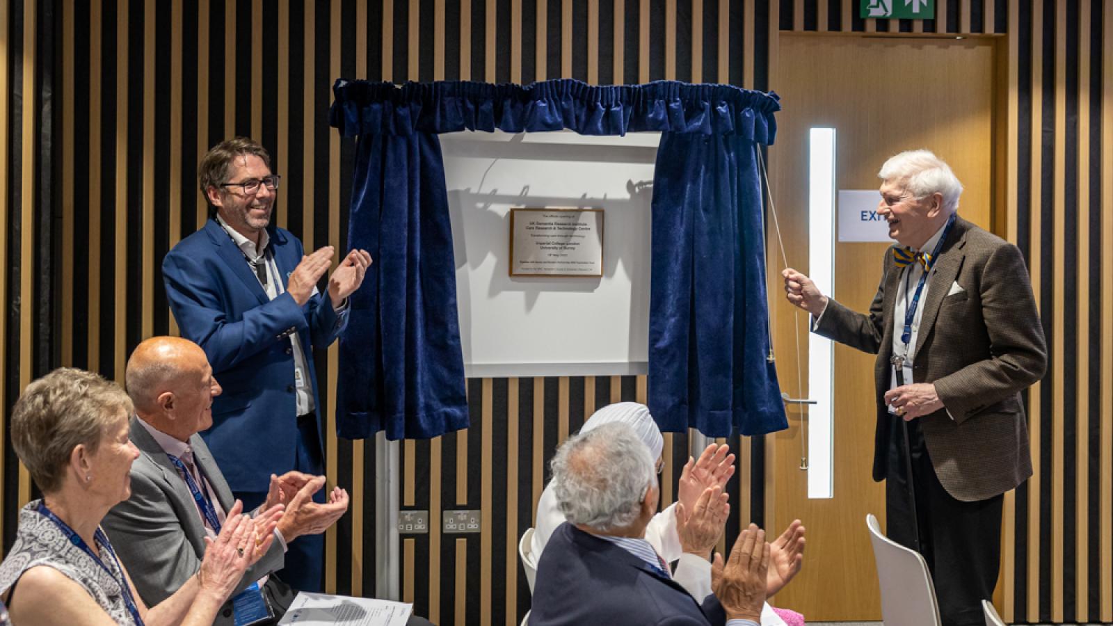 A plaque being unveiled by two individuals