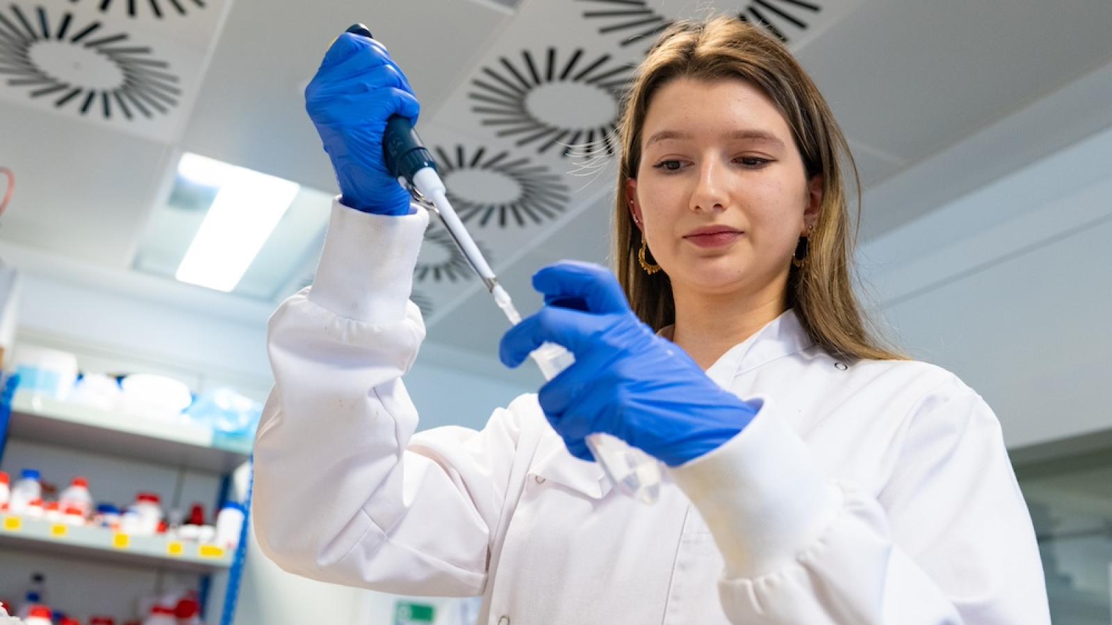 Scientist pipetting in a lab
