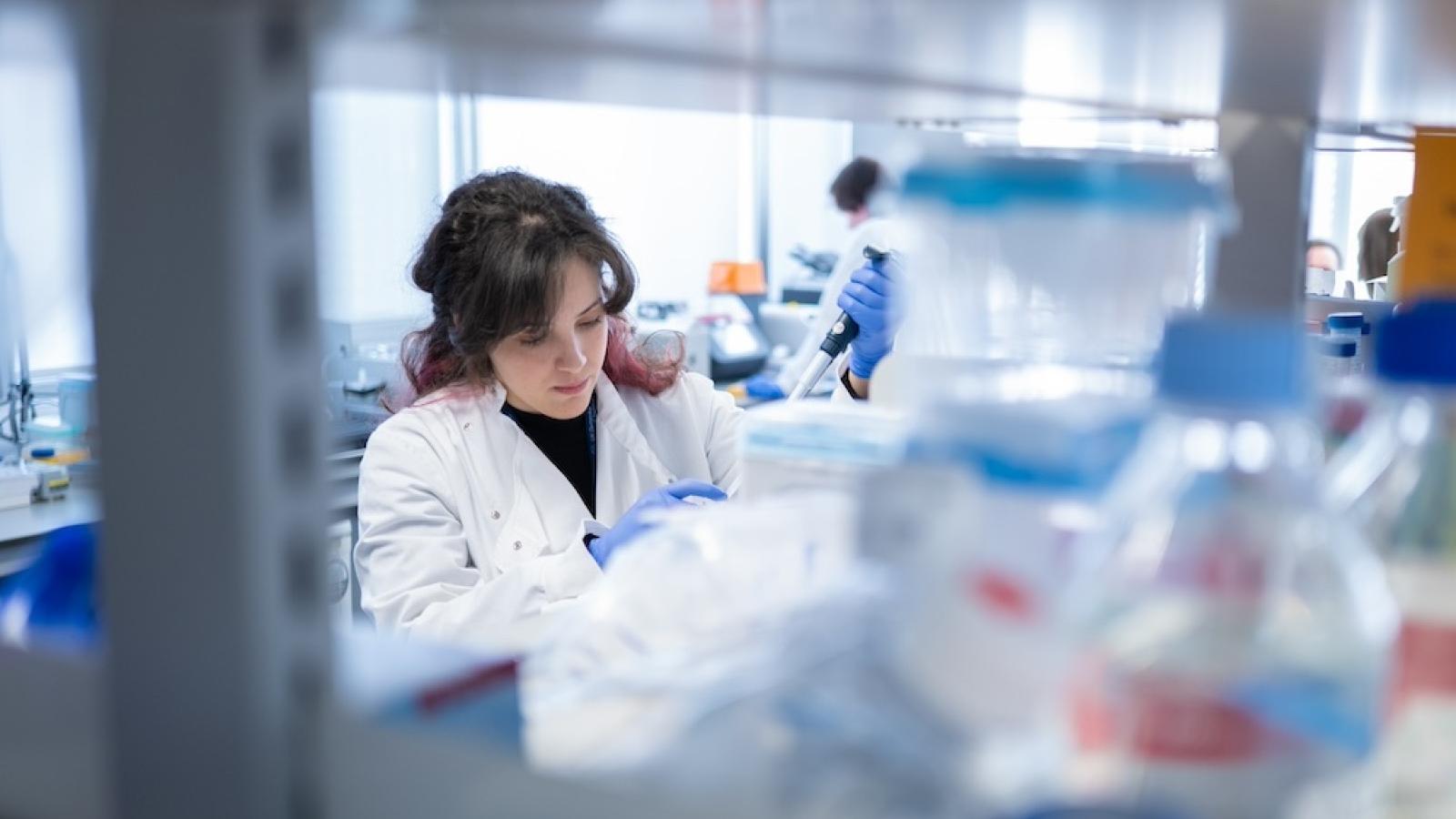Researcher in a white coat in a lab