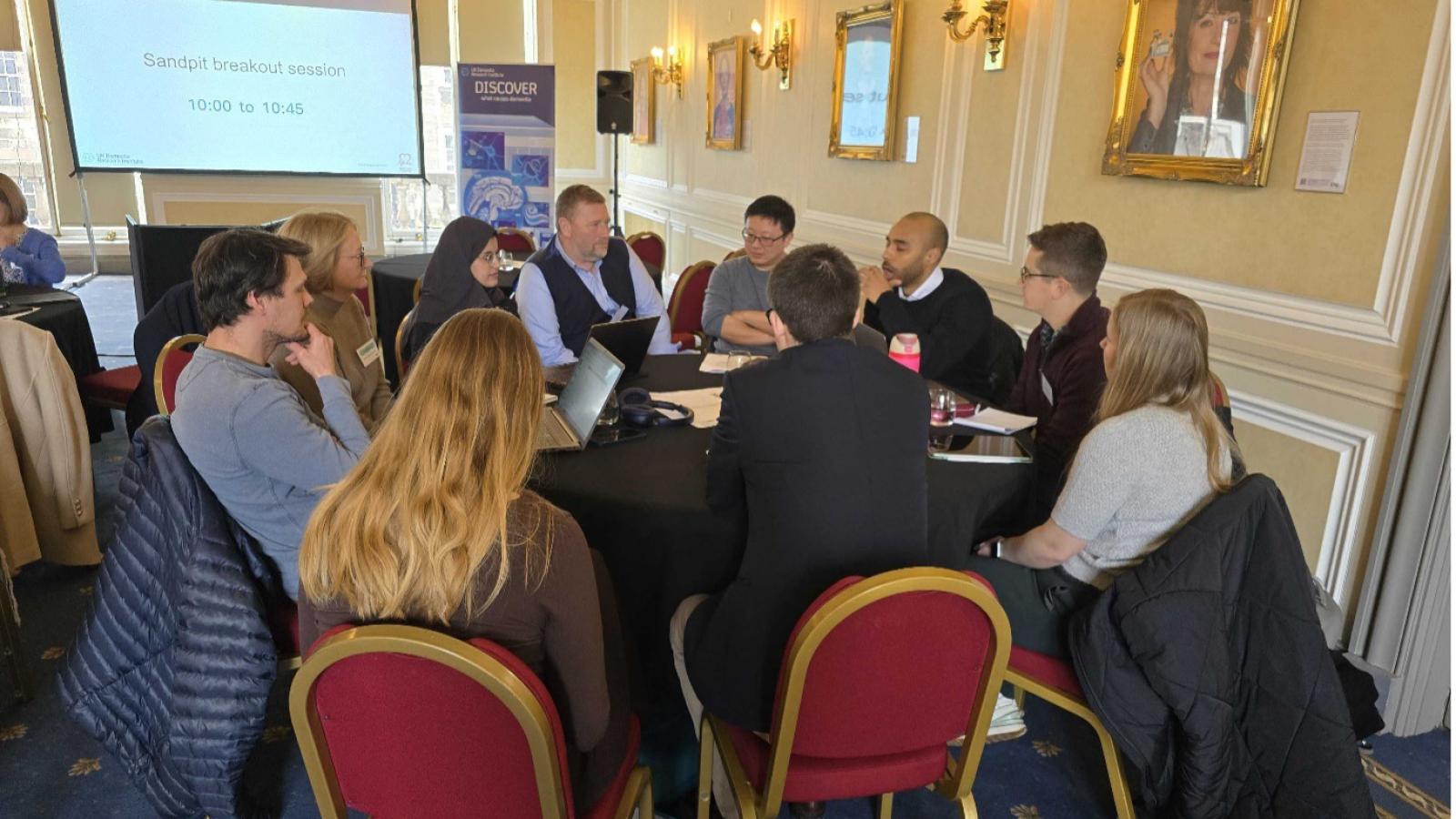 People sit around a table at the vascular meeting