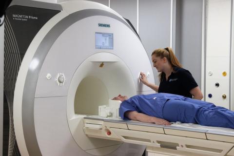 Superintendent Radiographer Charlotte Jardine examines a patient with an MRI machine