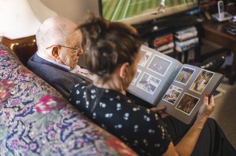 Man and woman looking over photographs