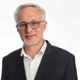 Male with white hair, white facial hair and glasses