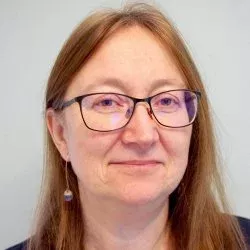 Female with light brown/ginger hair and glasses