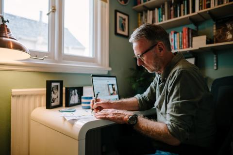 Man writing at desk