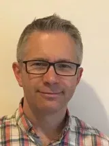 Male with grey hair and glasses