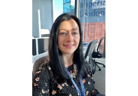 Female with long black hair sat in an office