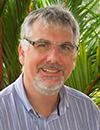 Male with grey hair, glasses and a beard