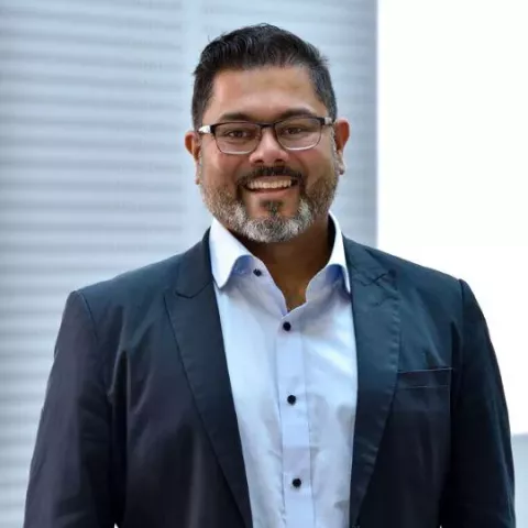 Photo of Deepak Srivastava, male with dark hair, grey beard and glasses