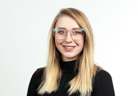 Female with long blonde hair and glasses