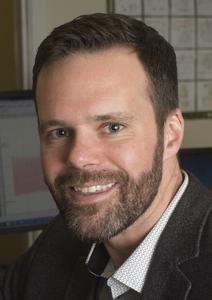 Male with dark hair and a short beard