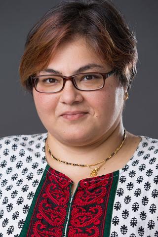 Female with short brown hair and rectangular glasses