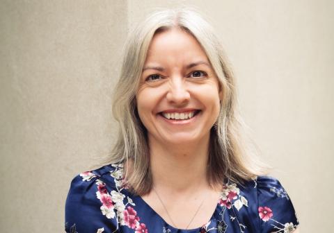 Smiling female with white-blonde hair