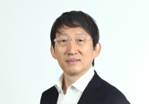 Headshot of Kei Cho, male with medium length dark hair and clear framed glasses