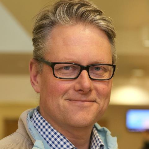 Man with light coloured hair and glasses