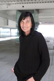 Tall female with black shoulder length hair and a fringe
