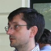 Side profile of a male with dark hair and glasses