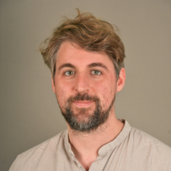 Male with light wavy hair and a short beard