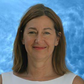 Louise Robinson, female with shoulder length light brown hair against a blue background