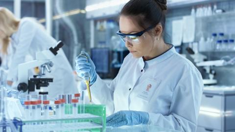 Scientist pipetting in a lab