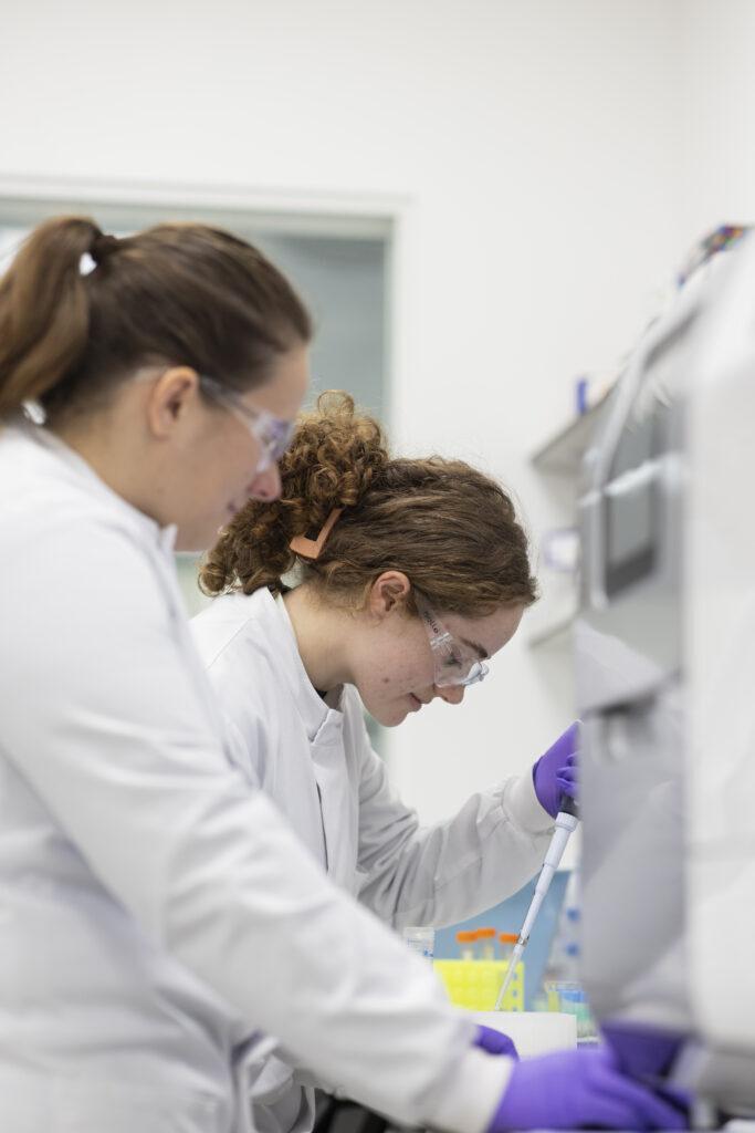 LifeArc scientists pipetting in the lab