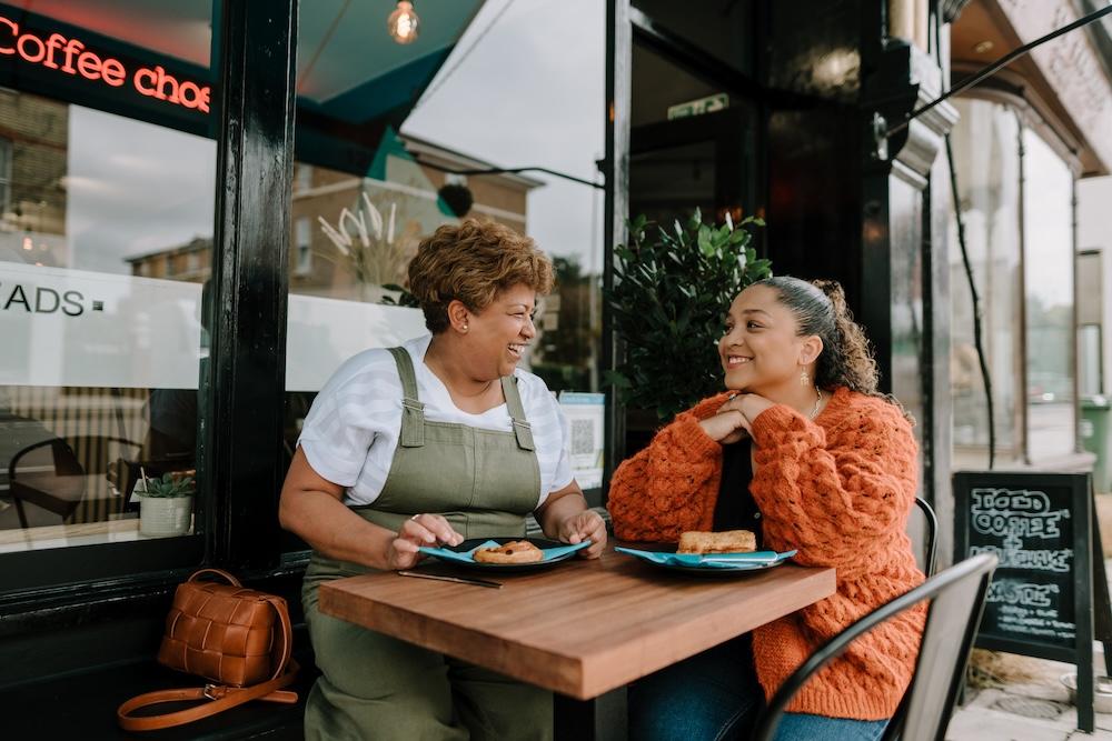 Women smiling at a cafe