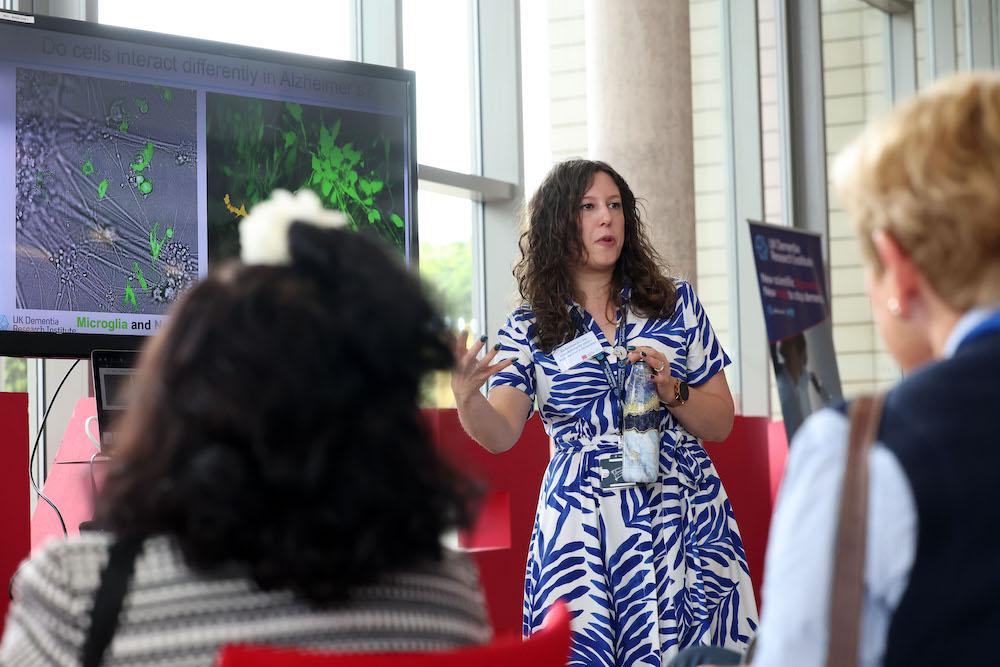 A researcher presents slides in front of an audience