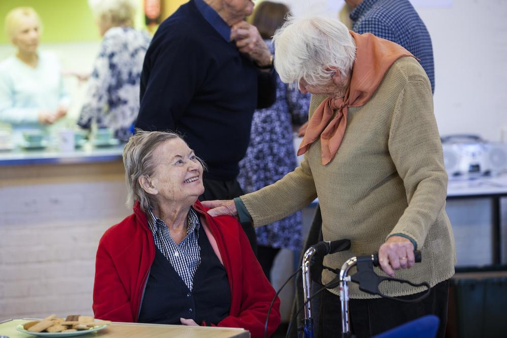 Older women chatting at a Alzheimer's society social event