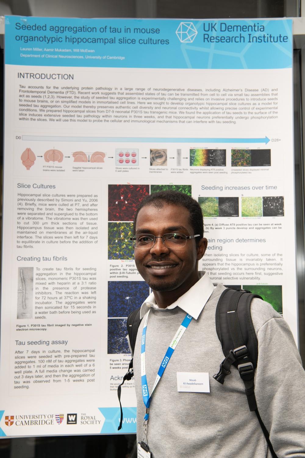 Person stands in front of a scientific poster