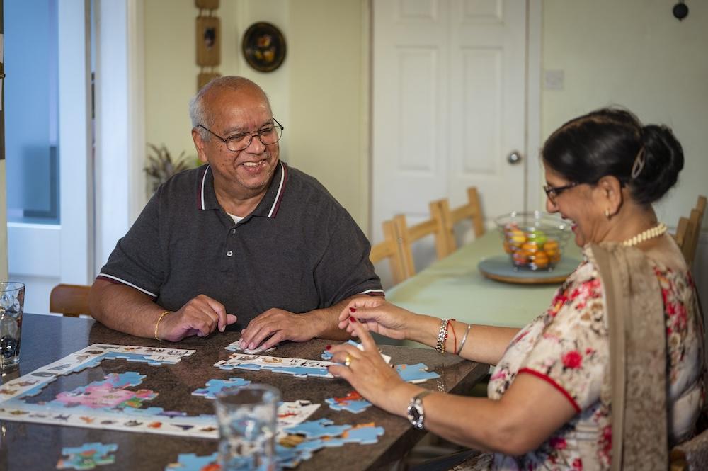 Couple playing a puzzle together