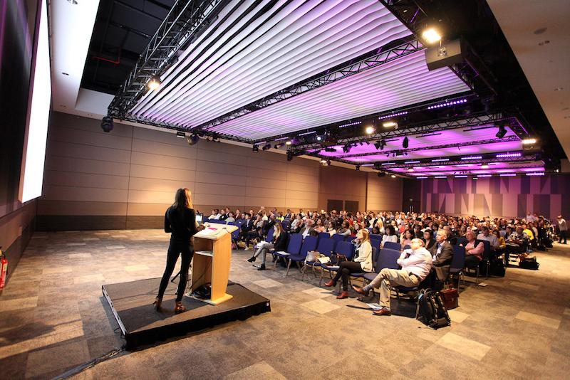 A woman presenting to a conference