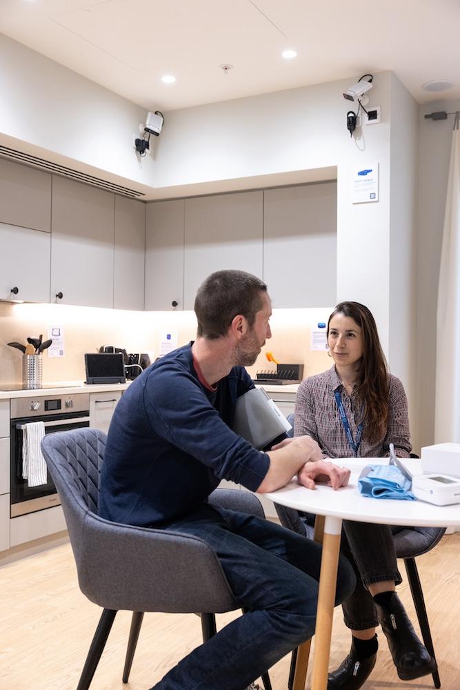 Two people sit at a table in the UK DRI living lab