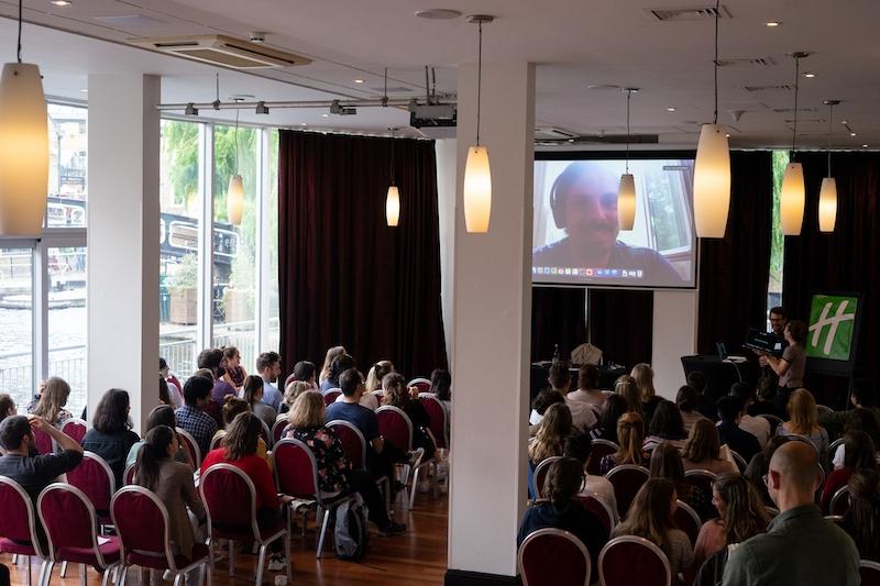 People watching a presentation on a large screen