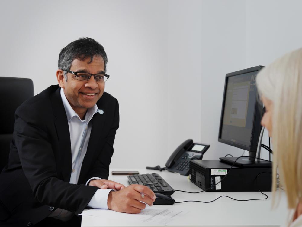 Siddharthan chandran in the clinic with a patient