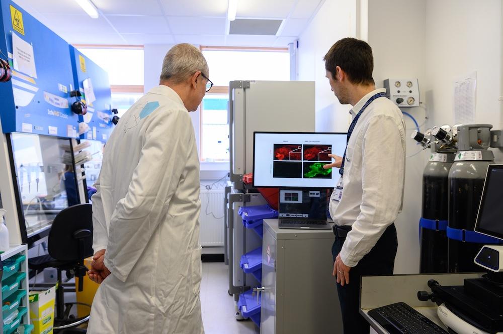 A researcher showcasing some microscopy images